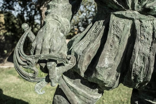 Badajoz, Spain - September the 7th, 2020: Francisco Pizarro statue. Sword closeup. Spanish Conqueror of Inca Empire. Made by Estanislao Garcia in 2003