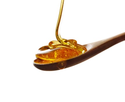 wooden spoon with honey isolated over white