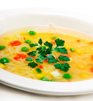 Closeup of colorful vegetable soup with parsley