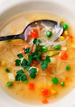Closeup of colorful vegetable soup with parsley