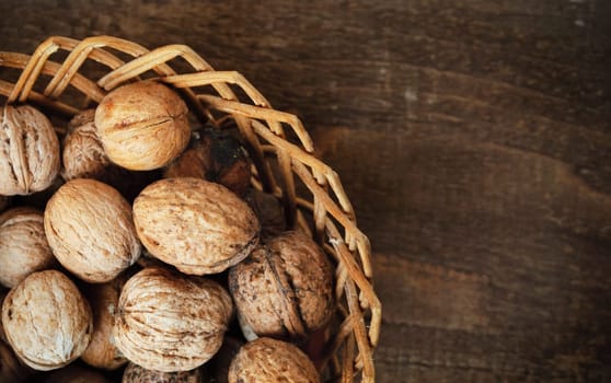 walnuts in the basket on wooden plank