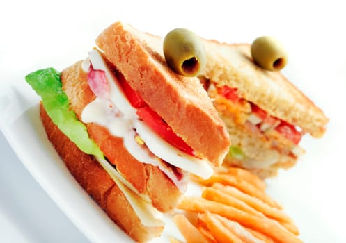 club sandwiches and french fries in white plate
