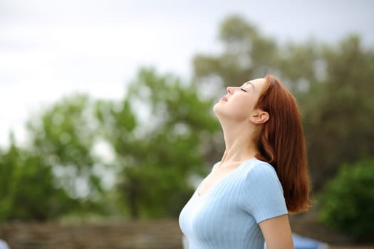 Woman breathing fresh air in a garden
