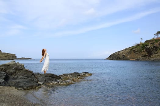 Full body of a lady breathing fresh air on the beach