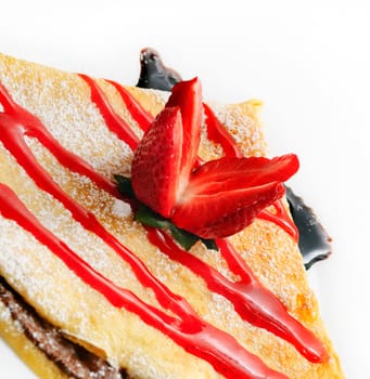 Decorative pancake with strawberry and chocolate syrup