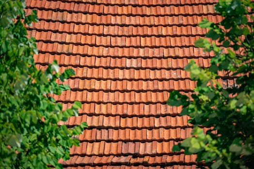 Old tiled roof of house in Europe. Close up view with details.
