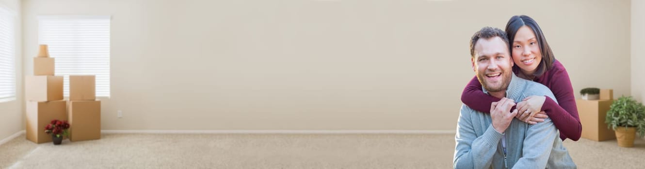 Mixed Race Caucasian and Chinese Couple Inside Empty Room with Moving Boxes Banner.