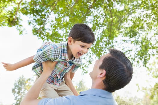 Happy Caucasian Father and Son Playing Together in the Park.