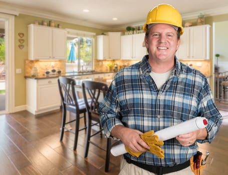 Contractor With Plans and Hard Hat Inside Custom Kitchen.