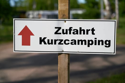 Signpost on a campsite in Germany with the inscription Access short camping (Zufahrt Kurzcamping)