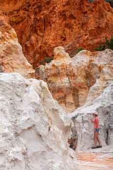 A female explores the Pinnacles a combination of white sands and red clay.  The iron clays have risen to the top from water rising in hot sun dislodging the particles to the upper surface.  Aboriginals used the white for ochre and it was an important trade  commodity