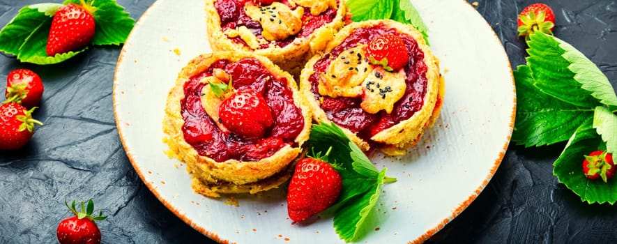 Strawberry shortcake pies on the plate.Tasty tartlets with fresh strawberries.Sweet dessert