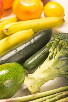 close up of Healthy food clean eating selection: fruit, vegetable, seeds, superfood, cereals, leaf vegetable on white with copy space. Diet concept. Flat lay, top view