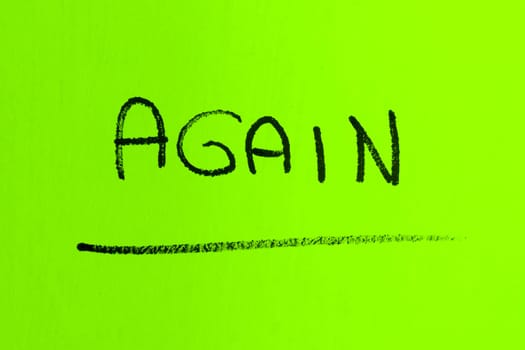 AGAIN word made with spray paint on green background