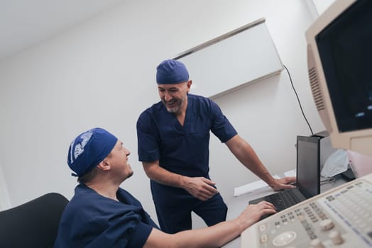 Orthopedist doctor team examining digital X-ray picture in clinic on a laptop computer. High quality photo. Selective focus