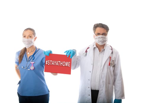 COVID-19 pandemic doctors and nurses hold a sign to request public to Stay at Home to stop the spread of infectious coronavirus COVID-19