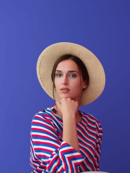 Portrait of young woman sitting on the chair isolated on purple background. Female model in casual and modern clothes posing in the studio