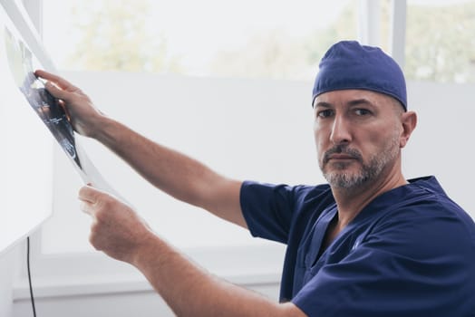 Orthopedist doctor examining X-ray picture at in hospital or clinic. High quality photo. Selective focus