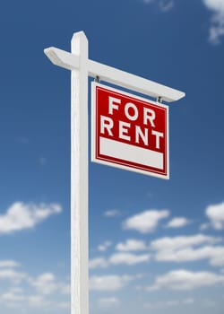 Right Facing For Rent Real Estate Sign on a Blue Sky with Clouds.