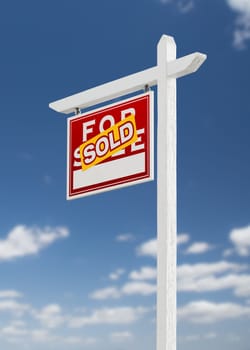 Left Facing Sold For Sale Real Estate Sign on a Blue Sky with Clouds.