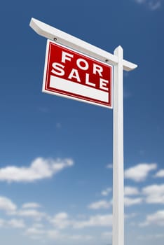 Left Facing For Sale Real Estate Sign on a Blue Sky with Clouds.