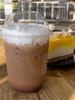 Iced mocha on wooden table, stock photo