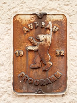 Berlin, Germany - March 07, 2019: Old original metal sign "Construction Program Berlin 1952"" on a house wall in Berlin-Kreuzberg."