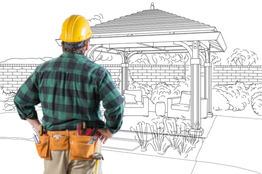 Contractor Standing Looking At Patio Pergola Design Drawing.