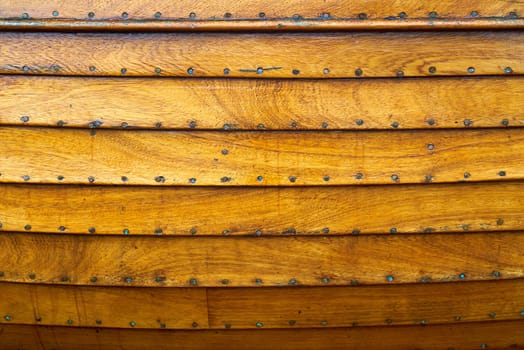 Wooden panels and plans of a small handmade boat.