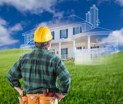 Contractor Standing Outdoors Looking Over Grass Site with Ghosted House.