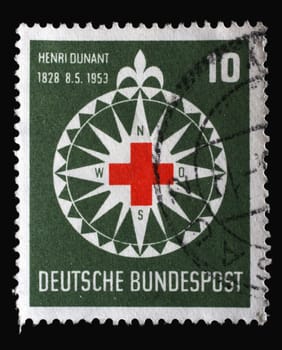 Stamp printed in Germany, shows symbol of the Red Cross in a stylized wind rose, circa 1953