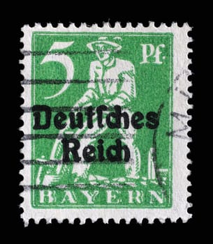 Stamp printed in printed in Bavaria with a "Deutsches Reich"" overprint shows Plowman, circa 1920"