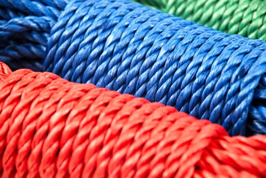 three coils of rope in green, blue and red