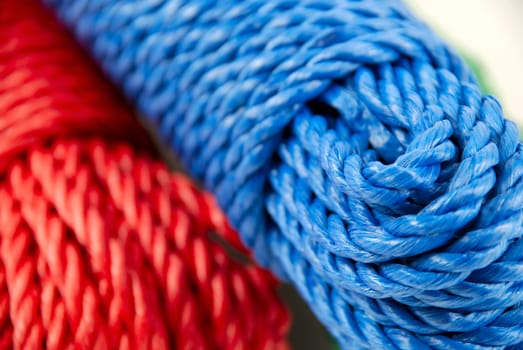 three coils of rope in green, blue and red