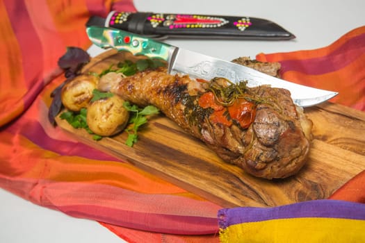 Orcanic roasted leg of turkey with vegetables on old wood