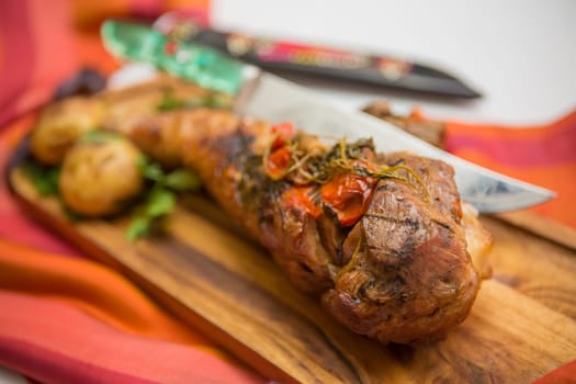 Orcanic roasted leg of turkey with vegetables on old wood