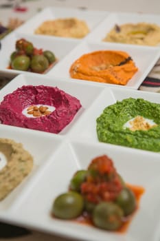 Delicious and healthy hummus set in white pate.