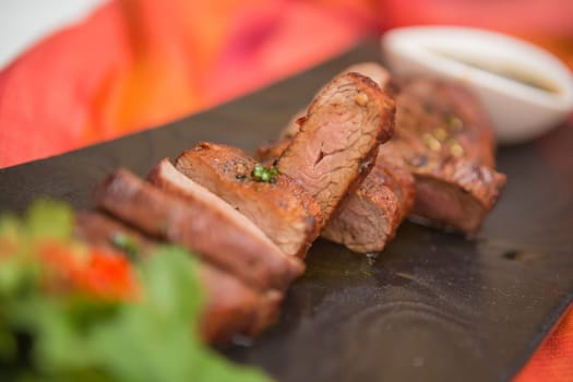 organic fresh ripe roasted beef meat with sauce on plate