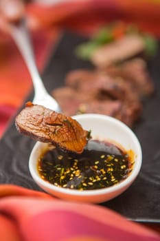 organic fresh ripe roasted beef meat with sauce on plate