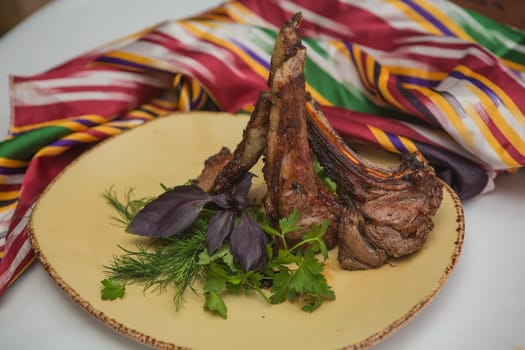 Grilled organic veal fillet on yellow plate with salad