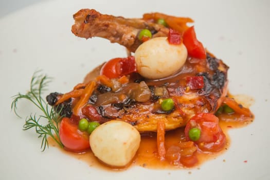 roasted chicken leg with vegetables, herbs and eggs