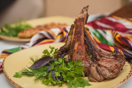 Grilled organic veal fillet on yellow plate with salad