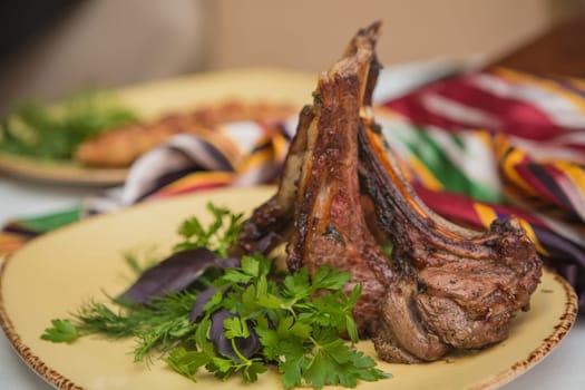 Grilled organic veal fillet on yellow plate with salad