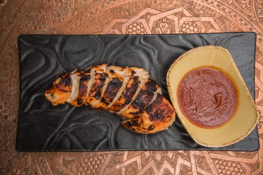 the cut chicken fillet baked in spices and tomato sauce,international kitchen