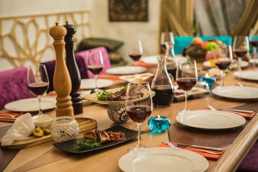 Served for a banquet table. Wine glasses with napkins, glasses and salads.
