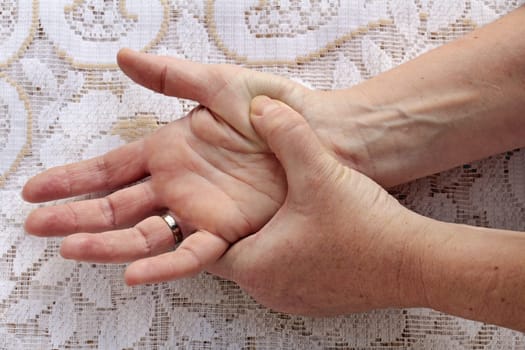 A woman has pain in her hands. A woman's hand hurts