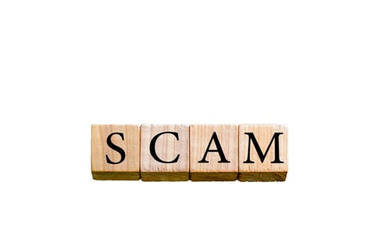 Word SCAM. Wooden small cubes with letters isolated on white background with copy space available. Concept image.