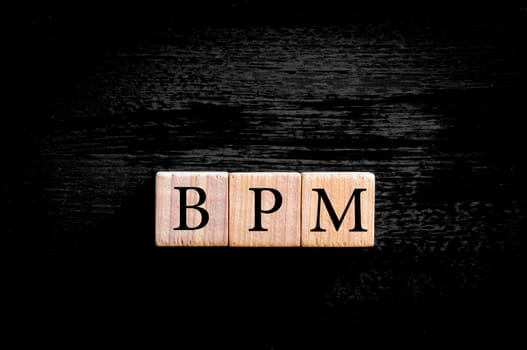 Word FUZZY. Wooden small cubes with letters isolated on black background with copy space available. Concept image.