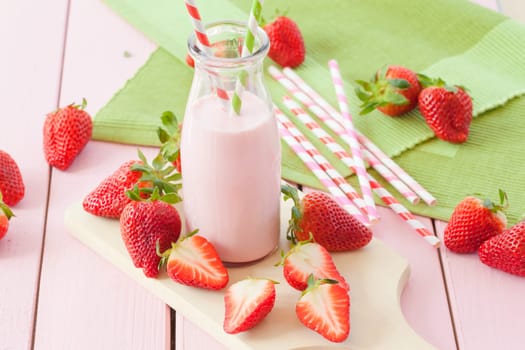 Vintage bottle of milk with fresh strawberries