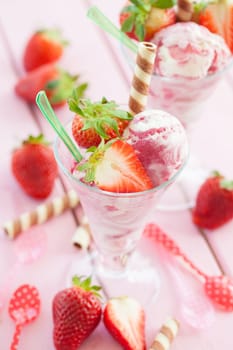 Milk ice cream with fresh strawberries on pink rustic background